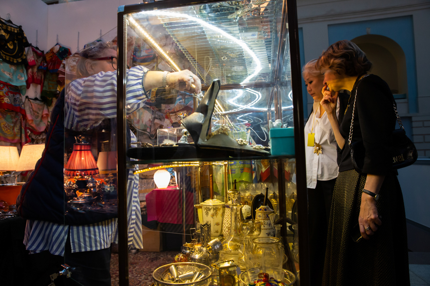 23.11.2022, Москва. 48-й Российский Антикварный Салон & Lifestyle "Искусство интерьера». Посетительницы перед витриной с экспонатами.